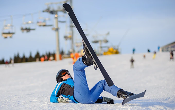 Fallen skier getting up awkwardly